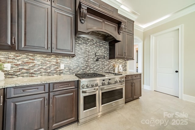 802 Capington Ln, Waxhaw, NC 28173 - kitchen featuring range with two ovens, premium range hood, backsplash, ornamental molding, and dark brown cabinets