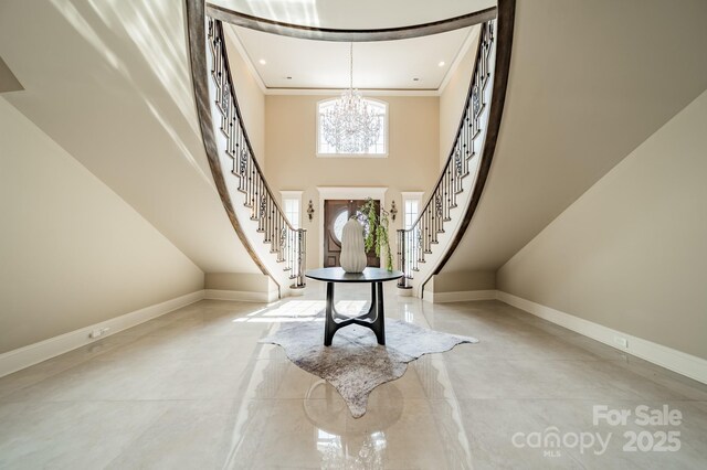 802 Capington Ln, Waxhaw, NC 28173 - foyer entrance with a chandelier, stairway, crown molding, concrete flooring, and a high ceiling