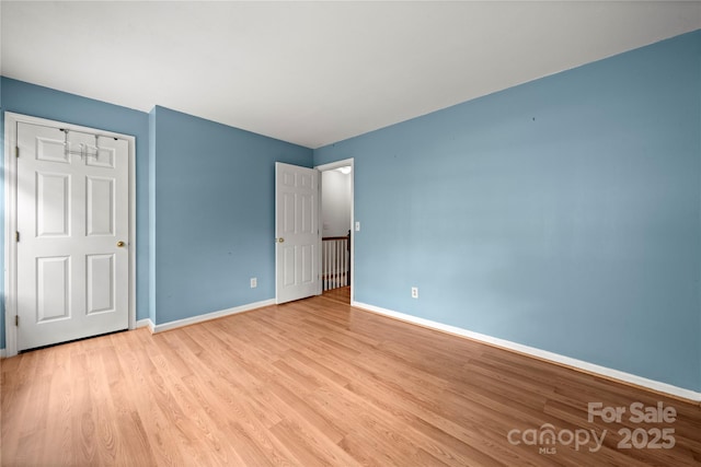 1230 Ridgebury Ter, Matthews, NC 28105 - unfurnished bedroom featuring light wood finished floors and baseboards