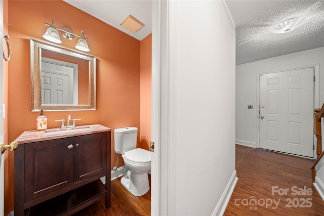 1230 Ridgebury Ter, Matthews, NC 28105 - half bathroom with wood finished floors, vanity, and a textured ceiling