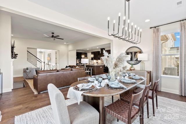 158 Nicholson Ln, Mooresville, NC 28115 - dining space featuring wood finished floors, stairs, a ceiling fan, a chandelier, and recessed lighting