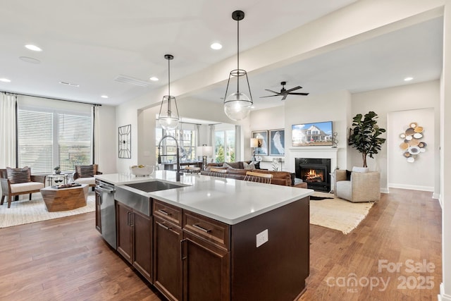 158 Nicholson Ln, Mooresville, NC 28115 - kitchen with wood finished floors, dishwasher, dark brown cabinetry, recessed lighting, and light countertops