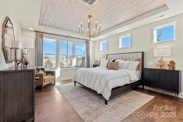 158 Nicholson Ln, Mooresville, NC 28115 - bedroom featuring a tray ceiling, a chandelier, and wood finished floors