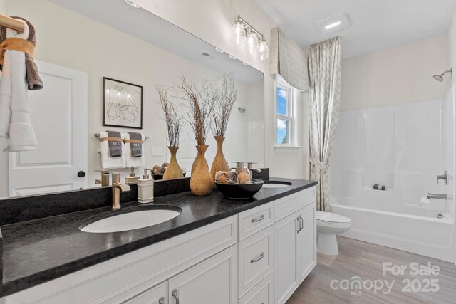158 Nicholson Ln, Mooresville, NC 28115 - bathroom featuring double vanity, shower / bathtub combination with curtain, and wood finished floors