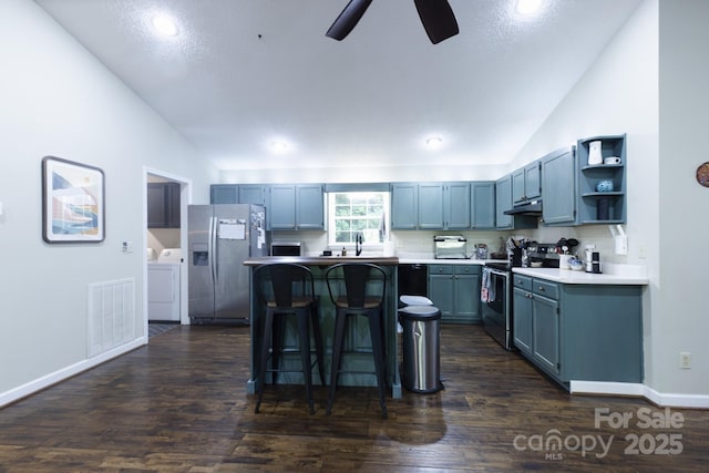 373 Fox Trace Dr, Sylva, NC 28779 - kitchen with range with electric cooktop, stainless steel refrigerator with ice dispenser, vaulted ceiling, a kitchen bar, and a kitchen island