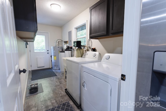 373 Fox Trace Dr, Sylva, NC 28779 - laundry area with water heater, cabinet space, washer and clothes dryer, and a textured ceiling