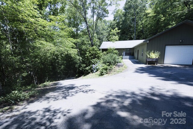 373 Fox Trace Dr, Sylva, NC 28779 - view of front of house featuring driveway, an attached garage, and a view of trees