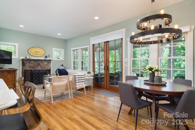 611 Hiawassee Rd, Black Mountain, NC 28711 - dining space with a chandelier, light wood-style flooring, recessed lighting, and a fireplace