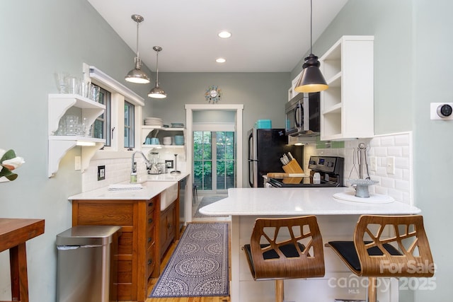 611 Hiawassee Rd, Black Mountain, NC 28711 - kitchen with open shelves, appliances with stainless steel finishes, backsplash, a peninsula, and light countertops