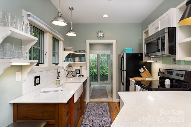 611 Hiawassee Rd, Black Mountain, NC 28711 - kitchen with open shelves, stainless steel appliances, light countertops, tasteful backsplash, and hanging light fixtures