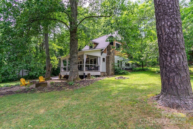 611 Hiawassee Rd, Black Mountain, NC 28711 - view of green lawn with a fire pit and a sunroom
