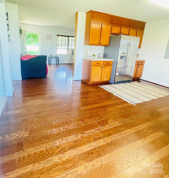 286 Little Wilkesboro Rd, Harmony, NC 28634 - kitchen featuring stainless steel fridge, wood finished floors, brown cabinets, light countertops, and open floor plan