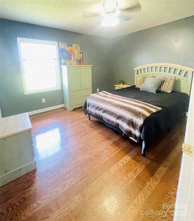 286 Little Wilkesboro Rd, Harmony, NC 28634 - bedroom featuring wood finished floors, a textured ceiling, and a ceiling fan