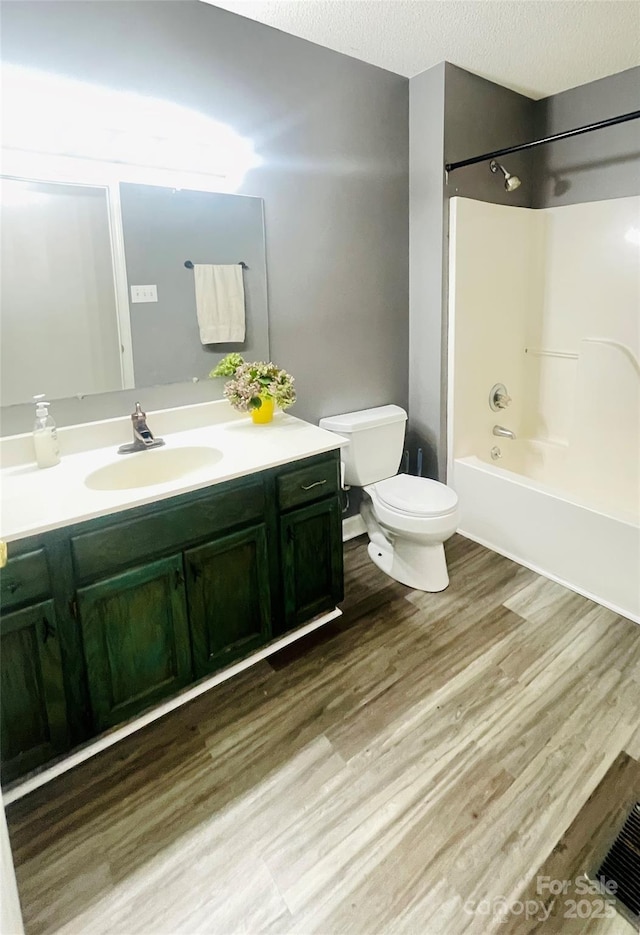 286 Little Wilkesboro Rd, Harmony, NC 28634 - full bathroom featuring vanity, wood finished floors, bathing tub / shower combination, and a textured ceiling
