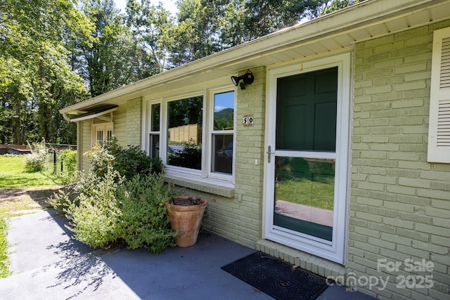 50 Taft St, Black Mountain, NC 28711 - view of exterior entry featuring brick siding and a patio