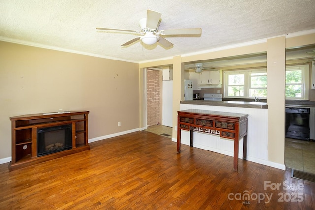 50 Taft St, Black Mountain, NC 28711 - living area featuring a textured ceiling, a ceiling fan, wood finished floors, ornamental molding, and a glass covered fireplace