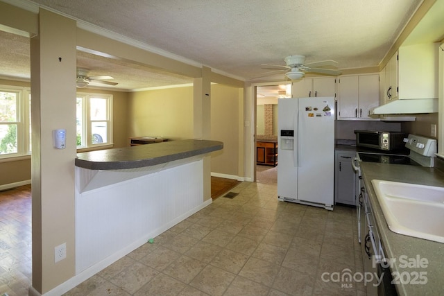 50 Taft St, Black Mountain, NC 28711 - kitchen featuring white refrigerator with ice dispenser, ceiling fan, dark countertops, crown molding, and under cabinet range hood