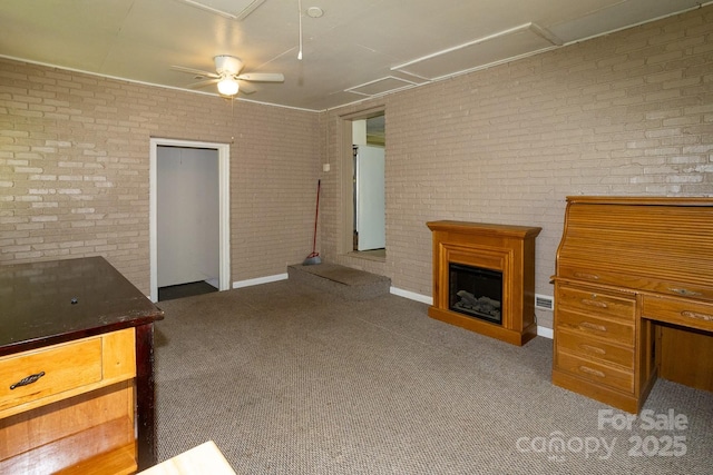 50 Taft St, Black Mountain, NC 28711 - unfurnished living room with attic access, brick wall, carpet flooring, ceiling fan, and a fireplace