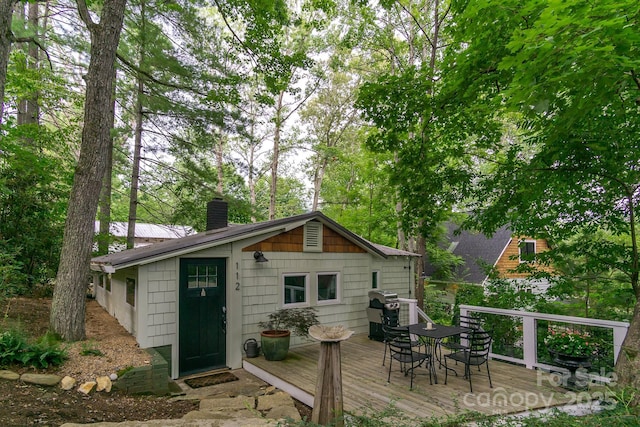 112 Byrd Rd, Black Mountain, NC 28711 - back of property featuring a wooden deck, a chimney, and outdoor dining area