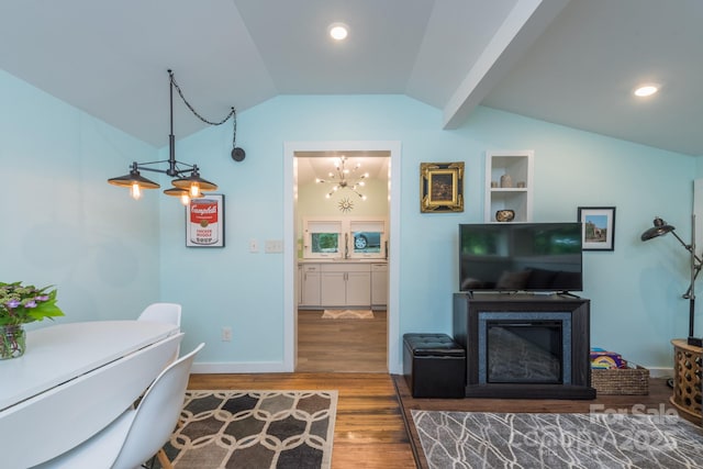 112 Byrd Rd, Black Mountain, NC 28711 - bedroom with vaulted ceiling, wood finished floors, a chandelier, a glass covered fireplace, and recessed lighting
