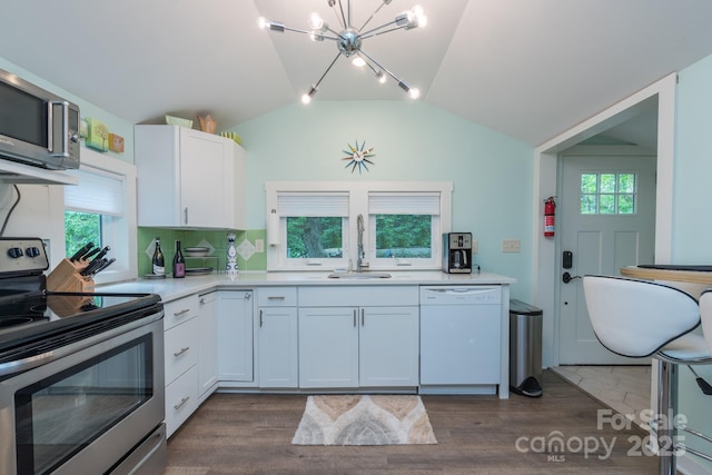 112 Byrd Rd, Black Mountain, NC 28711 - kitchen featuring appliances with stainless steel finishes, vaulted ceiling, a chandelier, light countertops, and white cabinetry