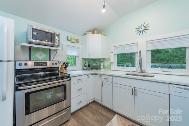 112 Byrd Rd, Black Mountain, NC 28711 - kitchen featuring appliances with stainless steel finishes, vaulted ceiling, light countertops, dark wood-style floors, and white cabinetry
