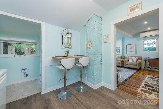 112 Byrd Rd, Black Mountain, NC 28711 - bathroom featuring vaulted ceiling, a wall mounted air conditioner, and wood finished floors