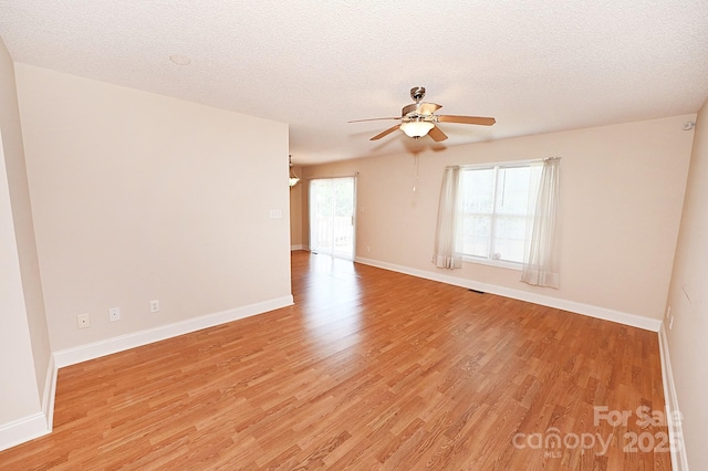 202 Pine Meadows St, Hickory, NC 28601 - spare room featuring light wood finished floors, ceiling fan, and a textured ceiling