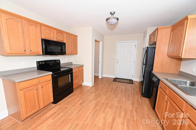 202 Pine Meadows St, Hickory, NC 28601 - kitchen featuring black appliances, light wood-style flooring, a textured ceiling, and light countertops
