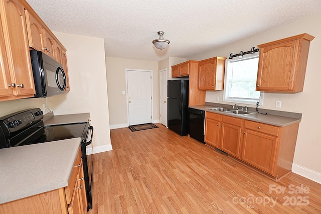 202 Pine Meadows St, Hickory, NC 28601 - kitchen with black appliances, light wood-style floors, light countertops, and a textured ceiling