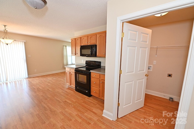 202 Pine Meadows St, Hickory, NC 28601 - kitchen with black appliances, healthy amount of natural light, light wood-style flooring, and a textured ceiling