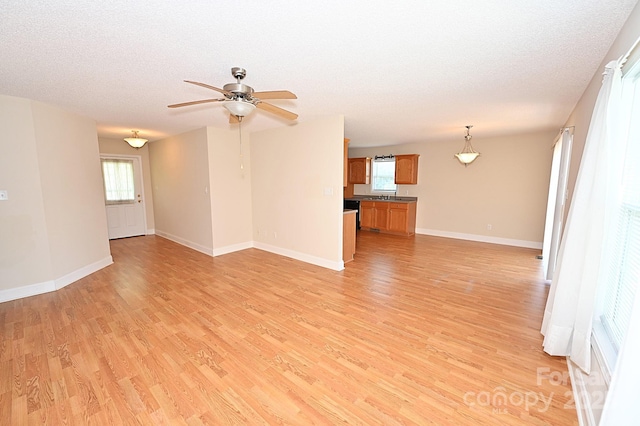 202 Pine Meadows St, Hickory, NC 28601 - unfurnished living room featuring light wood-style floors, a ceiling fan, and a textured ceiling