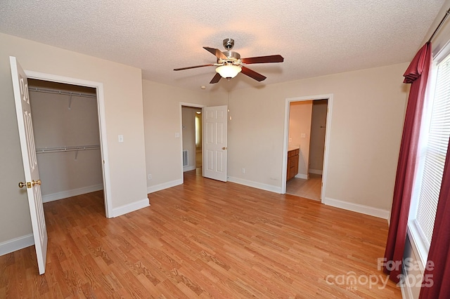 202 Pine Meadows St, Hickory, NC 28601 - unfurnished bedroom featuring light wood finished floors, a closet, a textured ceiling, a ceiling fan, and ensuite bathroom