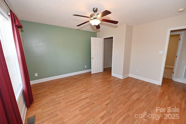 202 Pine Meadows St, Hickory, NC 28601 - unfurnished bedroom featuring light wood-type flooring, a textured ceiling, and ceiling fan