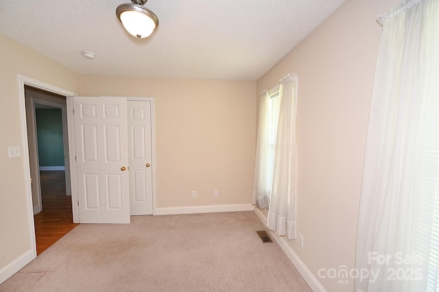 202 Pine Meadows St, Hickory, NC 28601 - unfurnished bedroom featuring carpet, a textured ceiling, and a closet