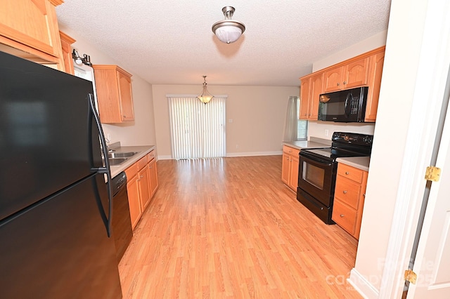 202 Pine Meadows St, Hickory, NC 28601 - kitchen featuring black appliances, light wood-type flooring, light countertops, a textured ceiling, and light brown cabinets