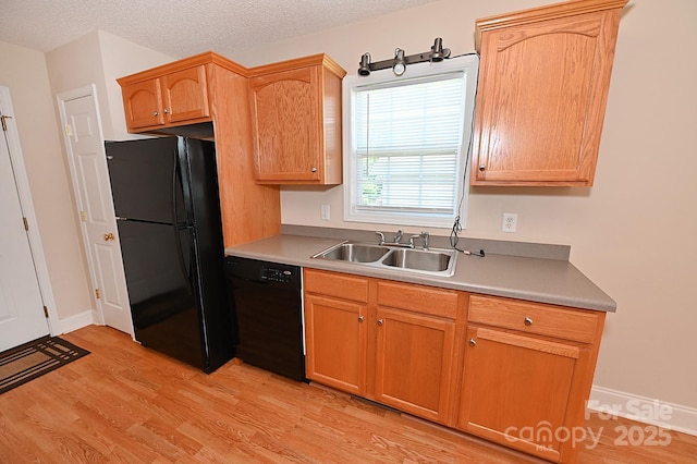 202 Pine Meadows St, Hickory, NC 28601 - kitchen with black appliances, light wood-type flooring, light countertops, and a textured ceiling