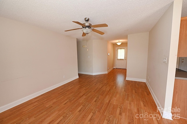 202 Pine Meadows St, Hickory, NC 28601 - empty room featuring light wood finished floors, a ceiling fan, and a textured ceiling