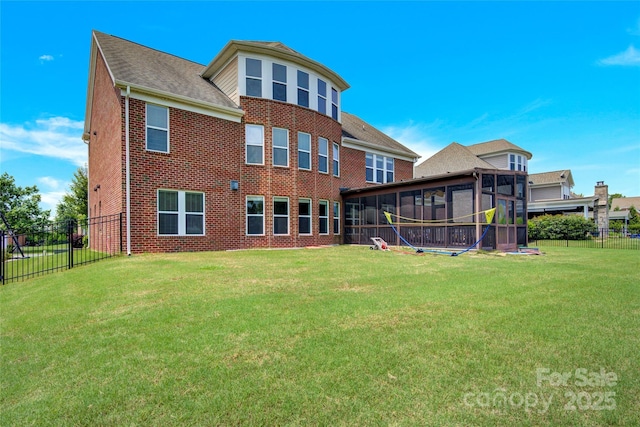 2805 Julian Glen Cir, Waxhaw, NC 28173 - rear view of property featuring a sunroom, brick siding, a fenced backyard, and a shingled roof