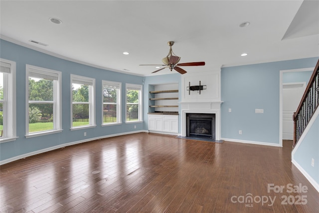 2805 Julian Glen Cir, Waxhaw, NC 28173 - unfurnished living room with a ceiling fan, a large fireplace, stairway, dark wood-style floors, and ornamental molding