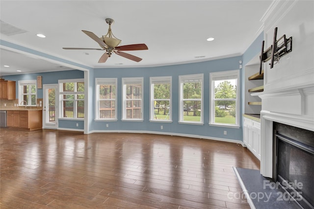 2805 Julian Glen Cir, Waxhaw, NC 28173 - unfurnished living room with a fireplace, a ceiling fan, dark wood-style floors, ornamental molding, and recessed lighting