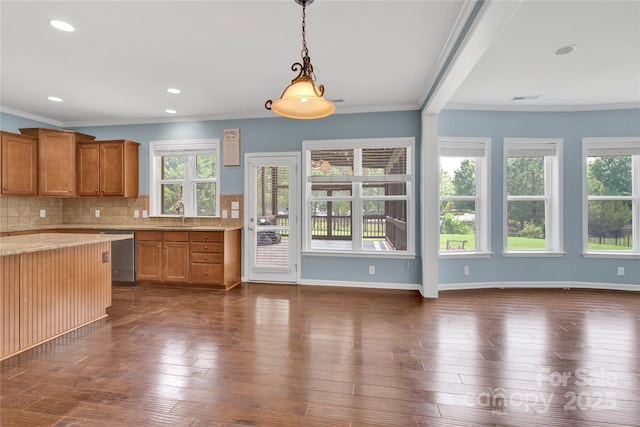 2805 Julian Glen Cir, Waxhaw, NC 28173 - kitchen with dishwasher, healthy amount of natural light, brown cabinetry, backsplash, and ornamental molding