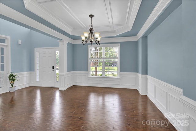 2805 Julian Glen Cir, Waxhaw, NC 28173 - spare room with a chandelier, a wainscoted wall, ornamental molding, dark wood-type flooring, and ornate columns