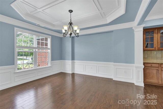 2805 Julian Glen Cir, Waxhaw, NC 28173 - unfurnished room with a chandelier, coffered ceiling, wainscoting, dark wood finished floors, and crown molding