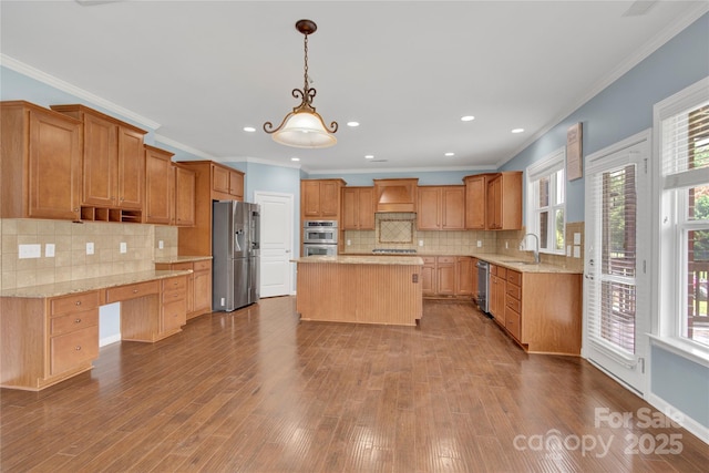 2805 Julian Glen Cir, Waxhaw, NC 28173 - kitchen with appliances with stainless steel finishes, ornamental molding, a center island, dark wood-style flooring, and backsplash