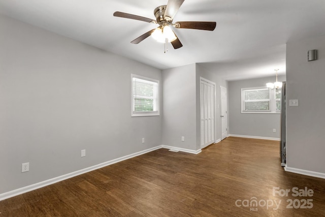6101 Mcgregor Dr, Charlotte, NC 28227 - unfurnished room with dark wood-style floors, plenty of natural light, a chandelier, and a ceiling fan
