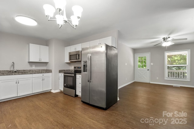 6101 Mcgregor Dr, Charlotte, NC 28227 - kitchen featuring appliances with stainless steel finishes, dark wood-style floors, white cabinetry, a chandelier, and a ceiling fan