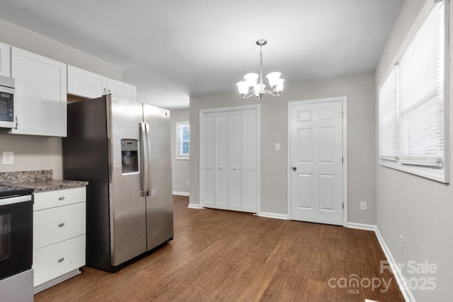 6101 Mcgregor Dr, Charlotte, NC 28227 - kitchen featuring stainless steel appliances, wood finished floors, white cabinetry, and a chandelier