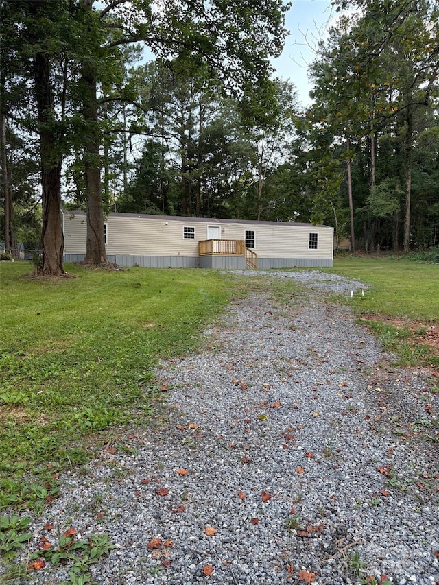 114 Woodberry Dr, Cherryville, NC 28021 - back of house featuring a lawn and gravel driveway