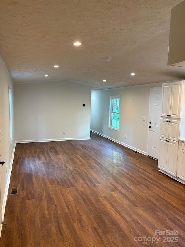 114 Woodberry Dr, Cherryville, NC 28021 - spare room with dark wood-type flooring, recessed lighting, lofted ceiling, and ornamental molding